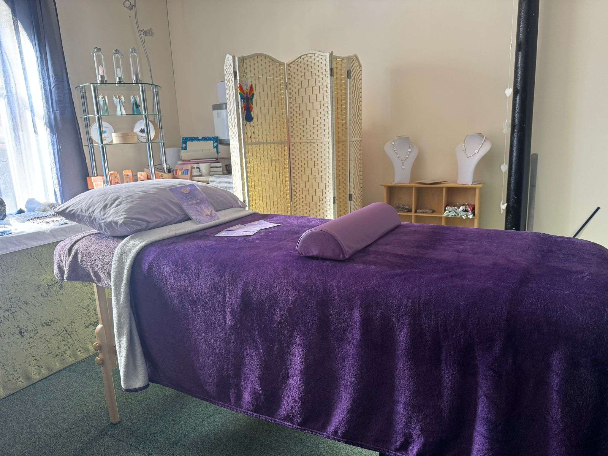The purple-covered treatment bed inside Kerry's healing room